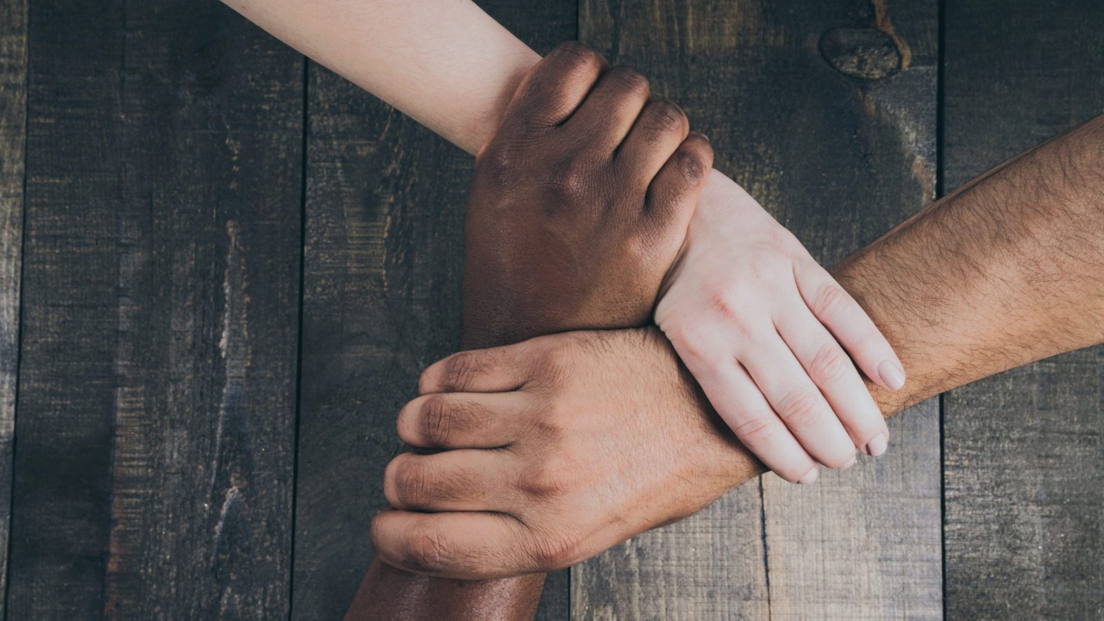 team-hands-linked-together